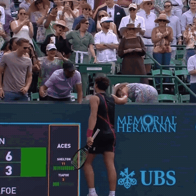 A Tennis Match Is Being Played In Front Of A Memorial Hermann Banner GIF