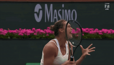 A Tennis Player Is Jumping In The Air While Holding A Racquet In Front Of A Bnp Paribas Banner GIF