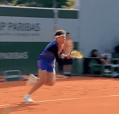 A Tennis Player Is Running On A Court With An Advertisement For Paribas Behind Him GIF
