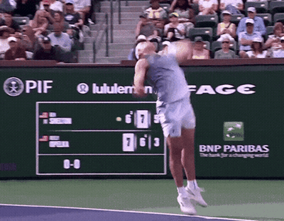 A Tennis Player Is Swinging A Tennis Racket In Front Of A Scoreboard That Says Bnp Paribas GIF