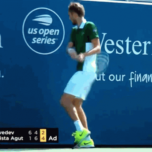 A Tennis Player Jumps In Front Of A Us Open Series Sign GIF