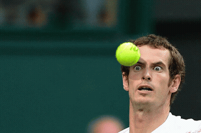 A Tennis Player Looks Up At A Tennis Ball With The Letter O On It GIF