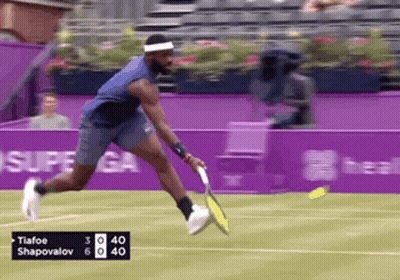 A Tennis Player Named Tiafoo Shapovalov Is Swinging His Racket GIF