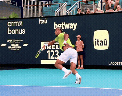 A Tennis Player On A Court With An Advertisement For Itau On The Wall GIF