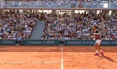 A Tennis Player On A Court With Emirates Fly Better Advertisements On The Sidelines GIF