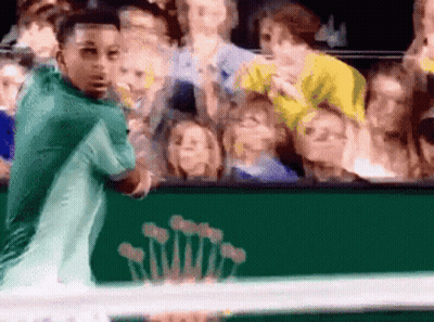 A Tennis Player Stands In Front Of A Green Rolex Sign GIF