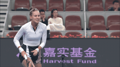 A Tennis Player Stands In Front Of A Harvest Fund Sign GIF