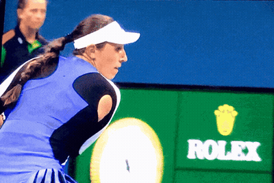 A Tennis Player Stands In Front Of A Rolex Advertisement GIF