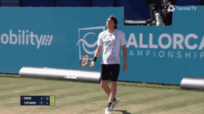 A Tennis Player Stands In Front Of A Sign That Says Mobility GIF