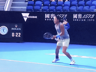 A Tennis Player Stands On A Court With A Rolex Sign In The Background GIF