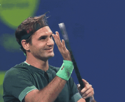 A Tennis Player Wearing A Headband Holds A Tennis Racquet GIF