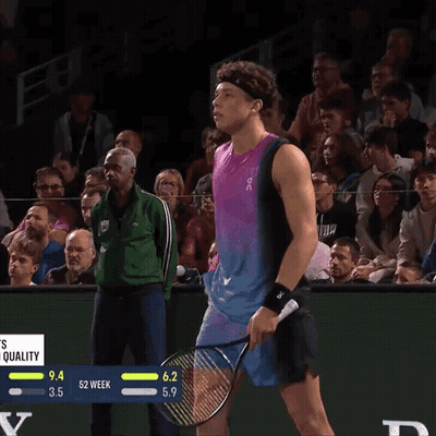 A Tennis Player Wipes His Nose With A Towel While Holding A Racquet GIF
