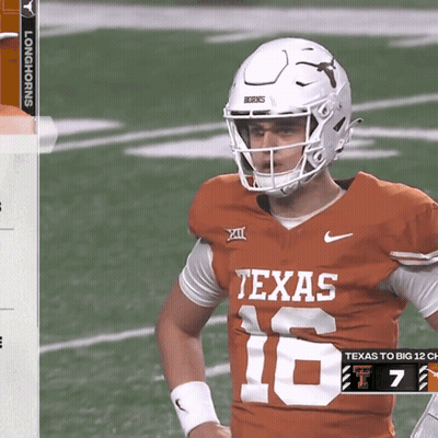 A Texas Football Player Wearing A White Helmet Stands On The Field GIF