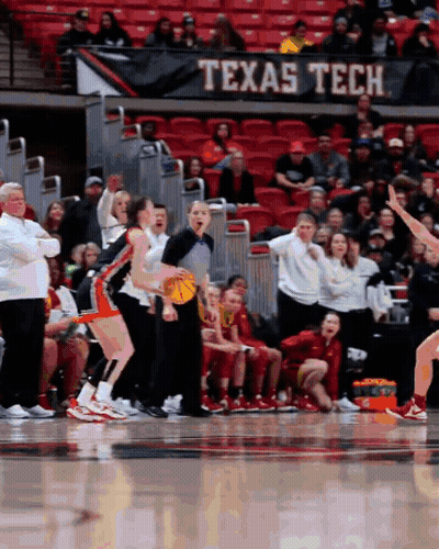 A Texas Tech Banner Hangs Over A Basketball Court GIF