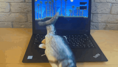 A Thinkpad Laptop With A Fish Toy On It GIF