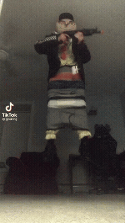 A Tiktok Video Of A Man Holding A Gun In His Hand GIF