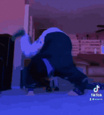 A Tiktok Video Of A Person Laying On Their Back With A Green Sock On GIF