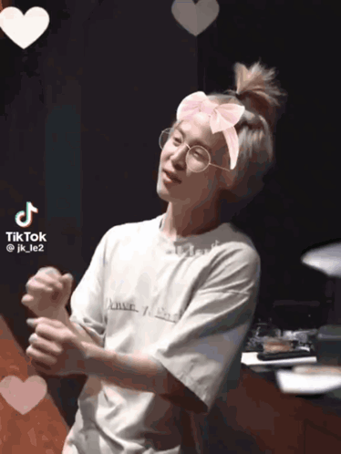 A Tiktok Video Of A Person Wearing Glasses And A Headband With Hearts Around Them GIF