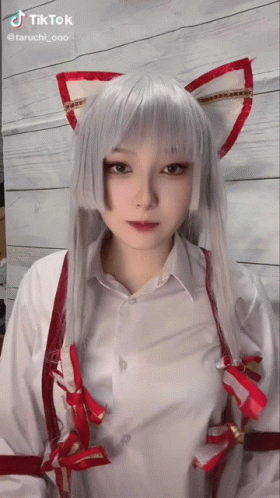 A Tiktok Video Of A Woman In A Cat Costume With White Hair And Red Ears GIF