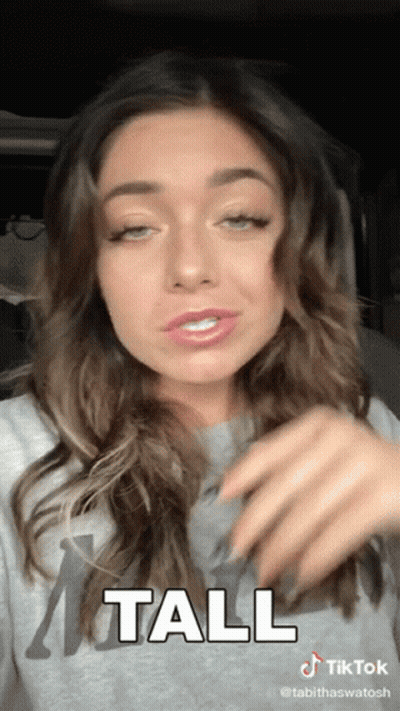 A Tiktok Video Of A Woman With The Word Tall On It GIF