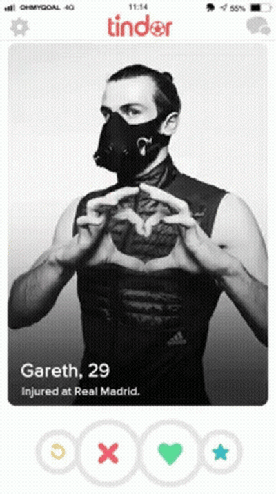 A Tinder Profile Of A Man Wearing A Mask And Making A Heart With His Hands GIF