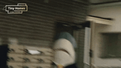 A Tiny Homes Advertisement With A Shark In The Foreground GIF