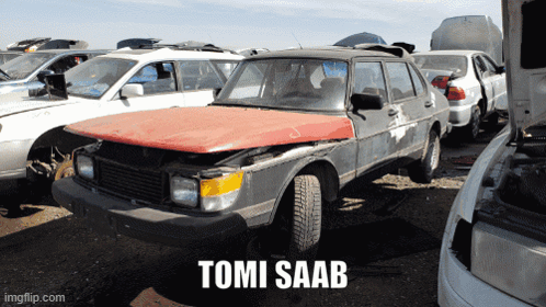 A Tomi Saab Is Sitting In A Junkyard With Other Cars GIF