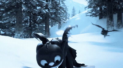 A Toothless Dragon Is Laying In The Snow With A Bird Flying In The Background GIF