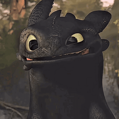 A Toothless From How To Train Your Dragon Is Smiling And Looking At The Camera GIF
