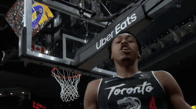 A Toronto Basketball Player Stands In Front Of A Sign That Says Uber Eats GIF