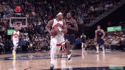A Toronto Raptors Player Dribbles A Basketball During A Game GIF