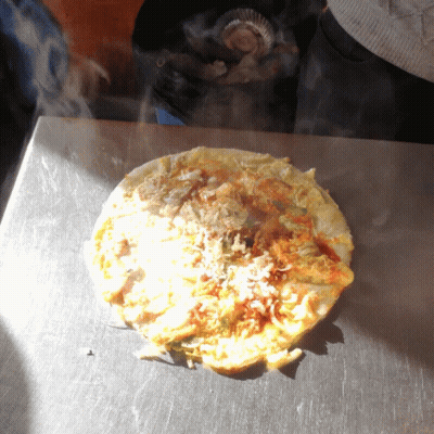 A Tortilla Is Being Cooked On A Stove Top GIF