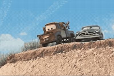 A Tow Truck Is Pulling A Car Down A Dirt Hill GIF