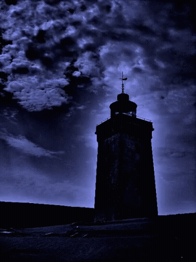 A Tower With A Cross On Top Of It Is Silhouetted Against A Dark Blue Sky GIF