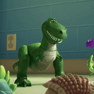 A Toy Dinosaur From The Movie Toy Story Is Smiling GIF