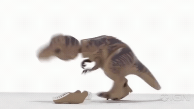 A Toy Dinosaur Is Walking On A White Surface With Its Mouth Open . GIF