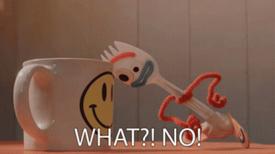 A Toy Fork Is Standing Next To A Mug That Says What ? No ! GIF