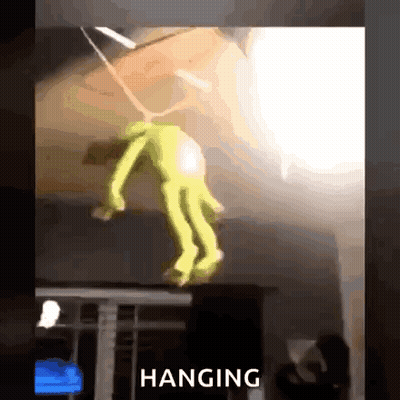 A Toy Is Hanging From The Ceiling In A Room With The Word Hanging Above It . GIF
