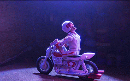 A Toy Motorcycle With A Maple Leaf On The Side Is Doing A Handstand GIF