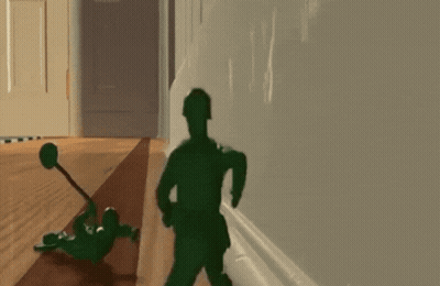 A Toy Soldier Laying On The Floor With A Hammer GIF