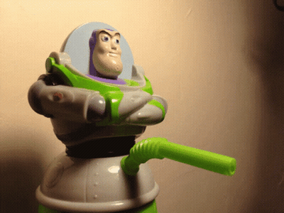 A Toy Story Buzz Lightyear Figure With A Green Straw GIF