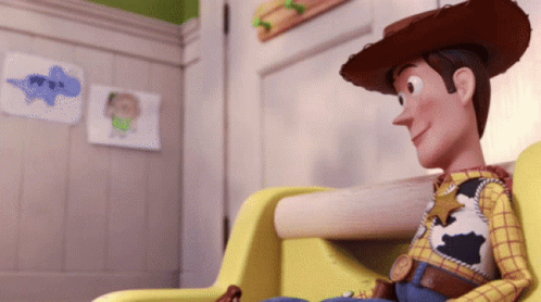 A Toy Story Character Is Sitting In A Chair GIF