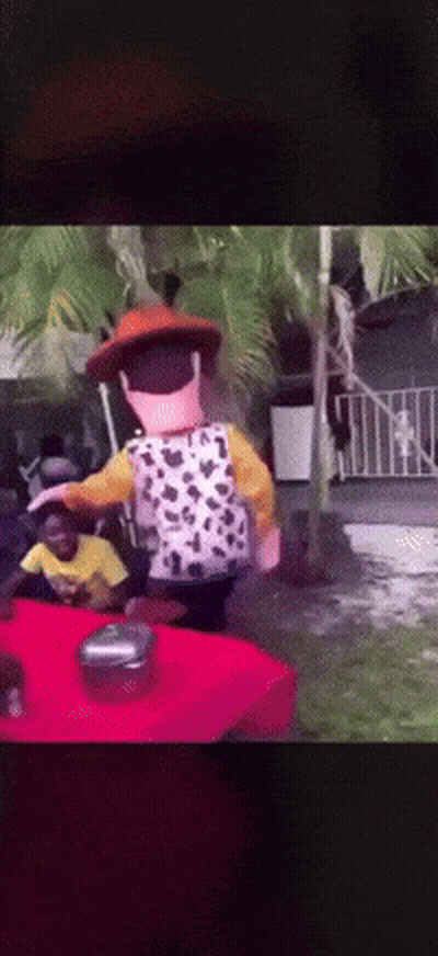 A Toy Story Character Is Standing On A Table GIF