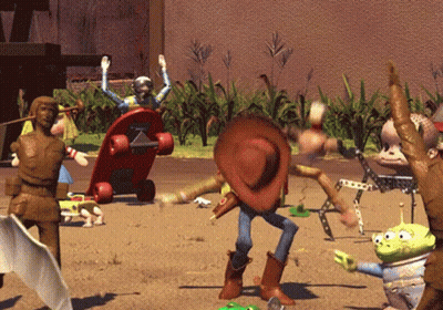 A Toy Story Scene With Woody And Aliens In The Sand GIF