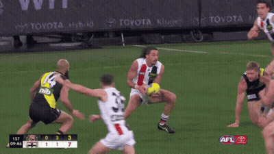 A Toyota Ad Can Be Seen Behind A Group Of Players On A Field GIF