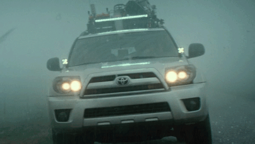 A Toyota Suv Is Driving Through The Fog GIF