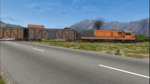 A Train Going Down A Road With A Mountain In The Background GIF