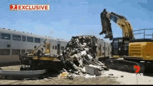 Demolition Of Train By Yellow Excavator With News Sign GIF