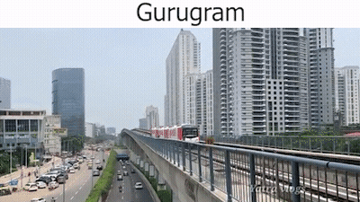 A Train Is Going Down A Bridge In A City With A Lot Of Buildings In The Background . GIF