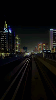 A Train Is Going Down The Tracks In The Dark GIF